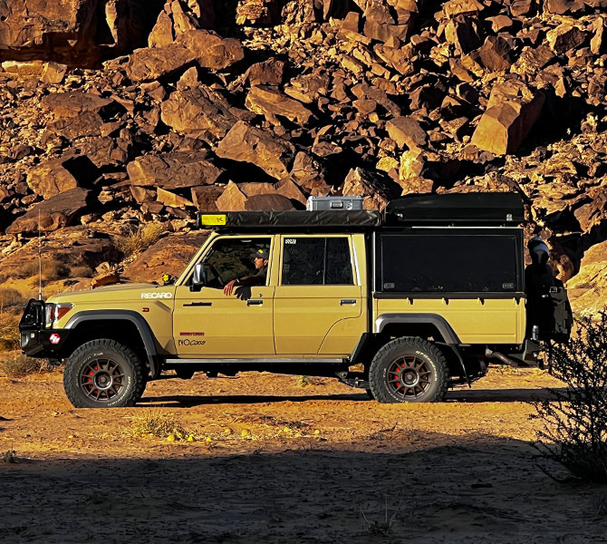 Toyota Land Cruiser with overland canopy and roof rack in the desert